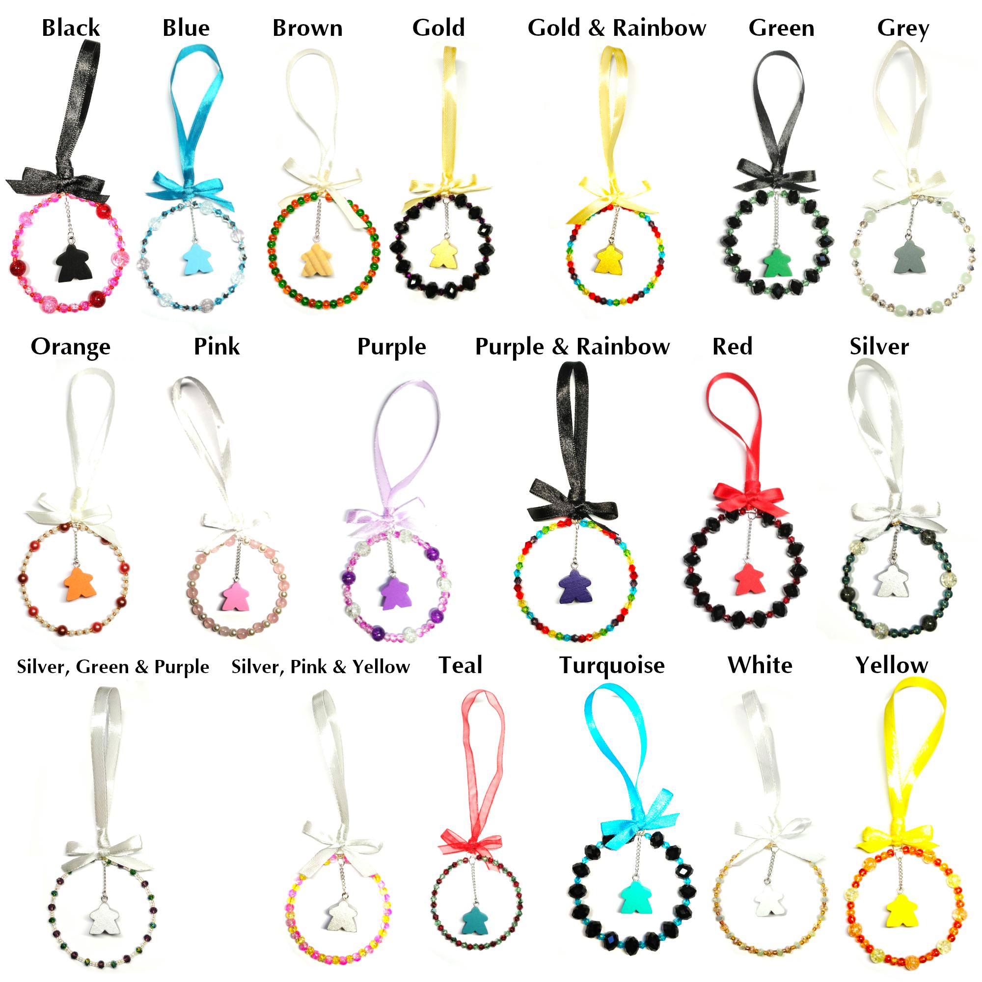  a beaded loop of wire with a meeple dice hanging from a chain in the centre, completed with a ribbon and bow to hang it.