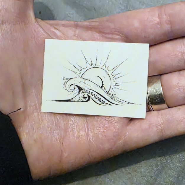 a temporary tattoo of a sunrise sitting in Jeb's hand