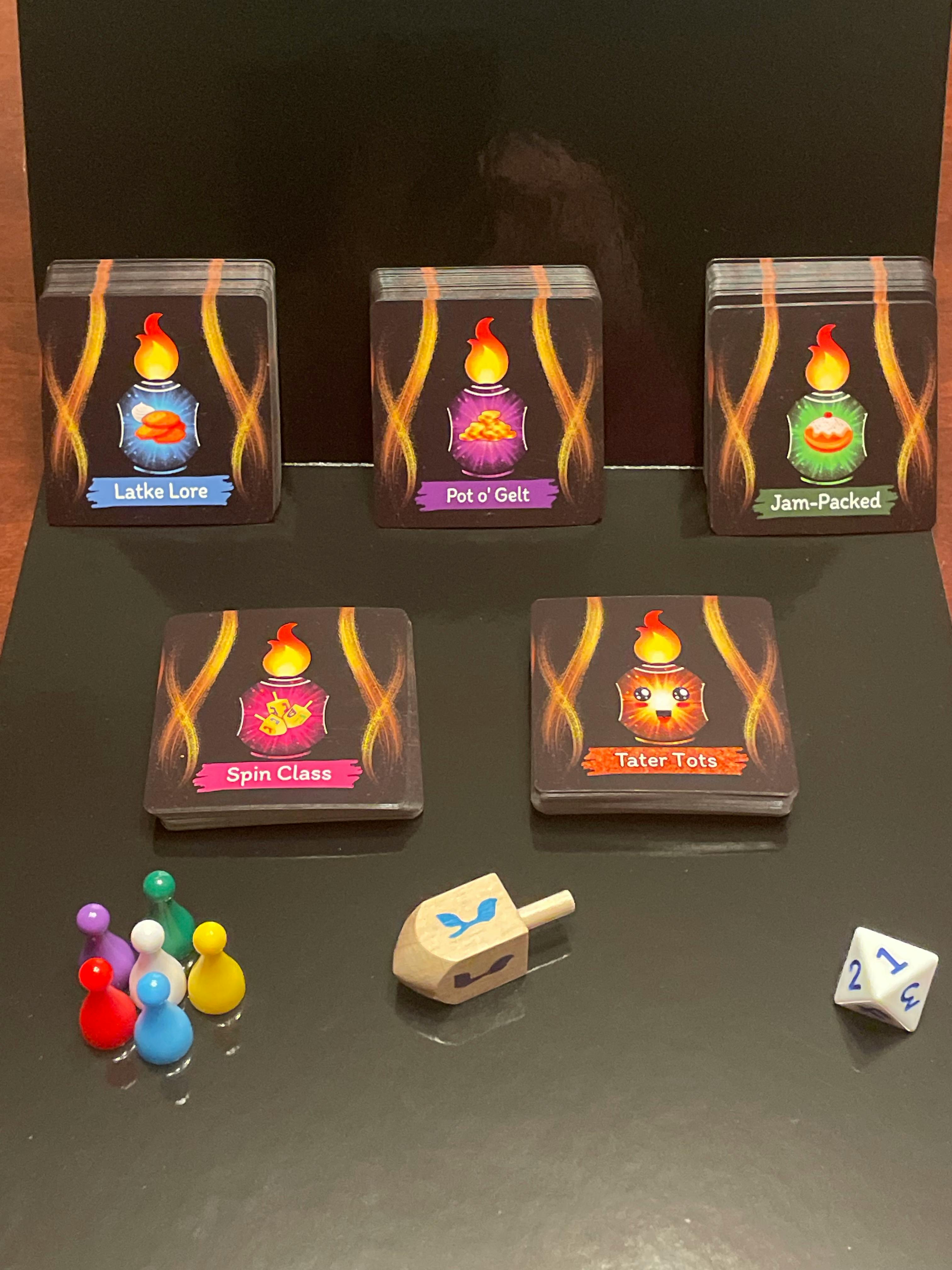 Gelt Galore card decks, dreidel, pawns, and dice
