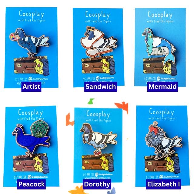 a grid of six wooden pins created from illustrations by Loadofolbobbins, showing a pigeon cosplaying as various things. Clockwise from top left an artist, a sandwich, a mermaid, Elizabeth the first, dorothy and a peacock.https://www.backerkit.com/c/projects/loadofolbobbins/loadofolbobbins-holiday-shop