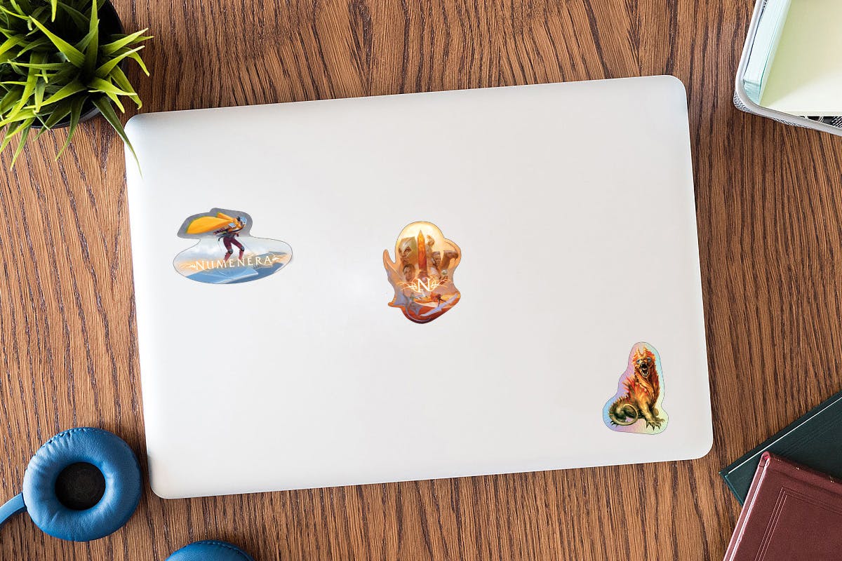 Mockup of a laptop with the three unlocked stickers on it.