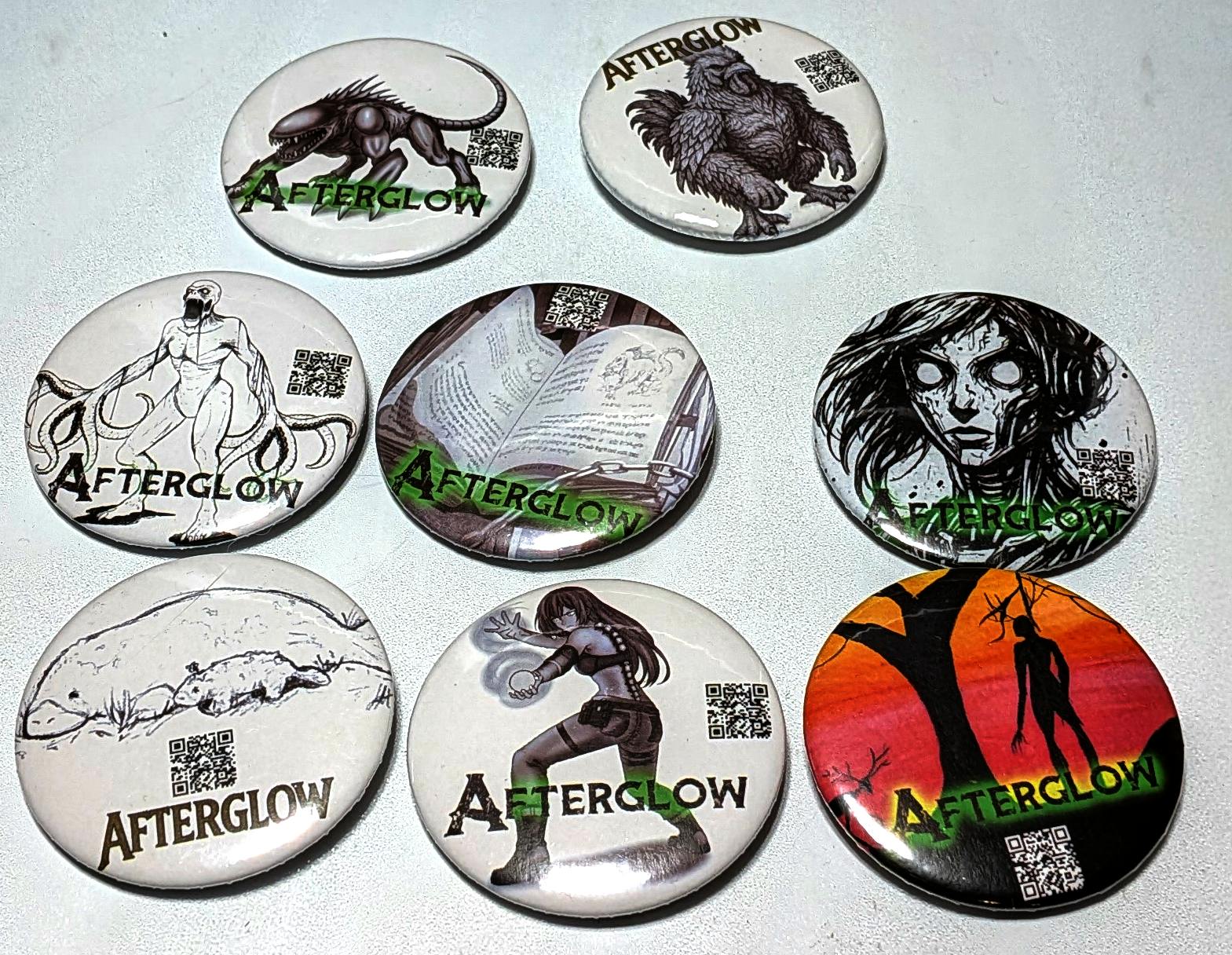 Buttons featuring the art of Afterglow