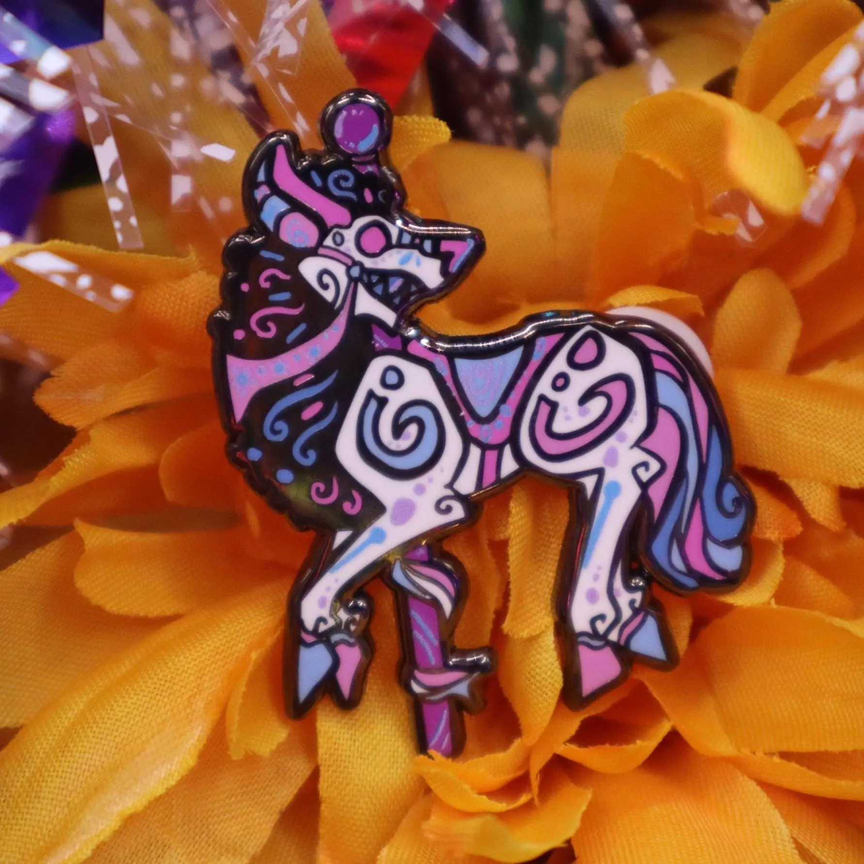 Trans flag leucrocotta cryptid carousel enamel pin