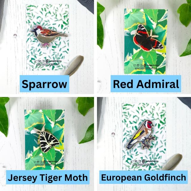 a grid of four wooden pins created from illustrations by Loadofolbobbins. Clockwise from top left a male sparrow, a red admiral butterfly, a European goldfinch and a Jersey tiger moth. https://www.backerkit.com/c/projects/loadofolbobbins/loadofolbobbins-holiday-shop