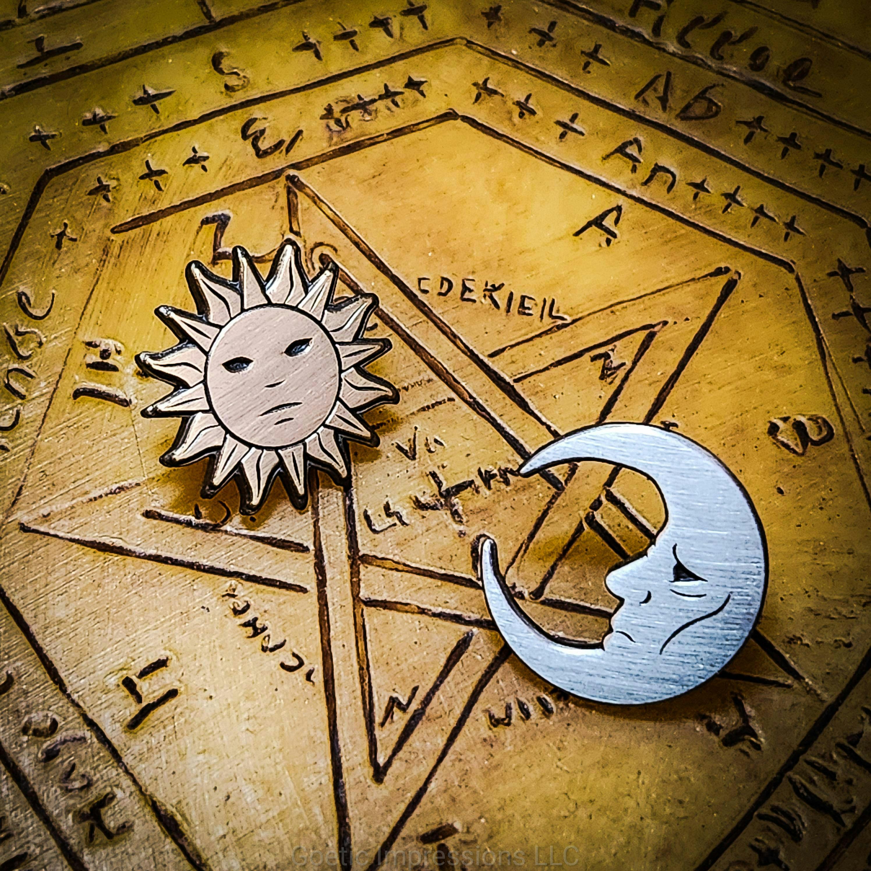 Sun and Moon antique enamel pins on a sigillum dei aemeth