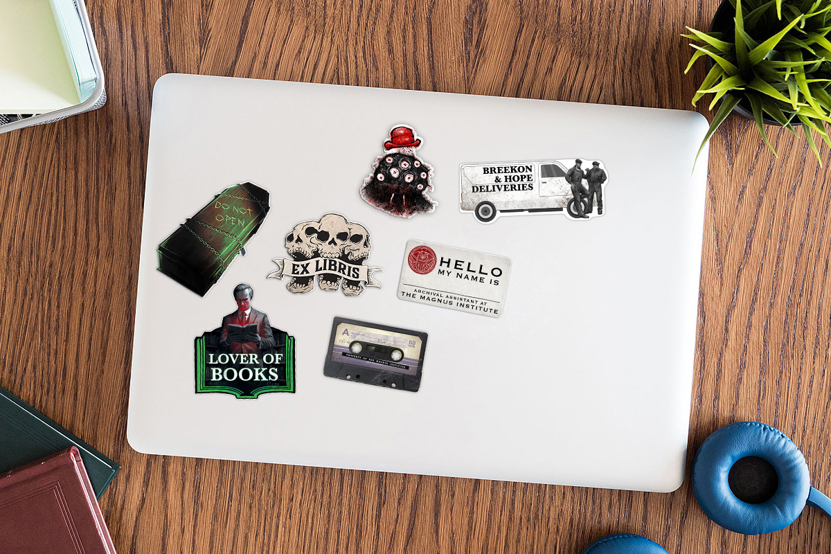 Image of a laptop with seven stickers on it.