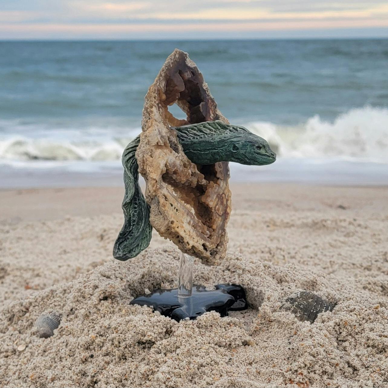 Moray Eel sculpture on fossil coral stand