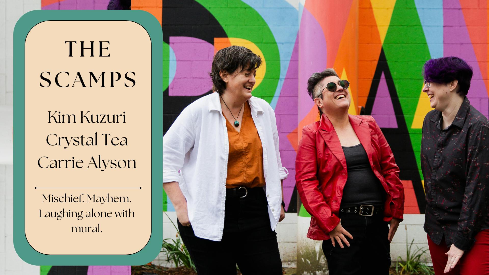 The Scamps. Kim Kuzuri, Crystal Tea, Carrie Alyson. Mischief. Mayhem. Laughing alone with mural... Three genderqueers in front of a mural.