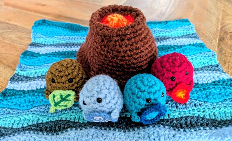  All 4 elemental sprite plushies with a crocheted volcano and crocheted ocean