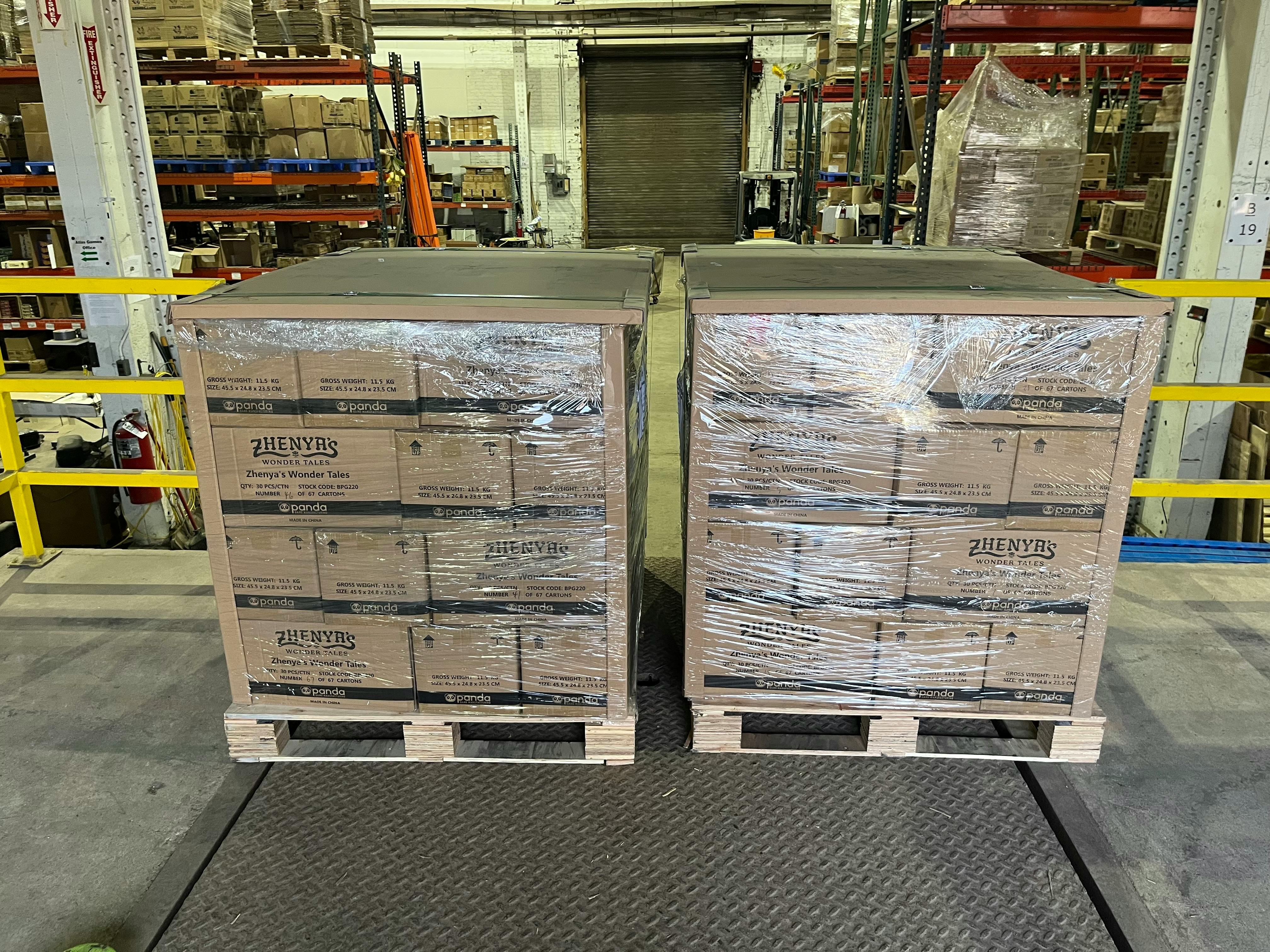 Two pallets loaded with cartons of Zhenya's Wonder Tales on a warehouse loading dock